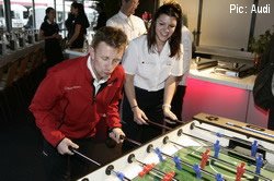 Allan McNish demonstrates Scottish football skills to Audi colleague Katherine Legge