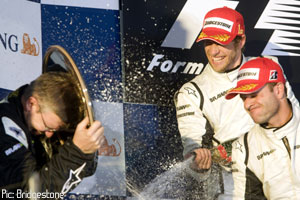 Brawn, Button and Barrichello celebrate on the podium
