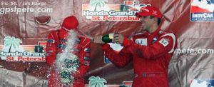 Justin Wilson drenches Ryan Briscoe on the St Pete podium