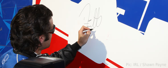 Dario Franchitti signs his autograph at the Texas Motor Speedway
