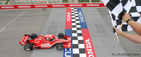 Dario Franchitti crosses the line first