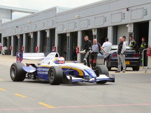 Bikers attending a track day check out the cars