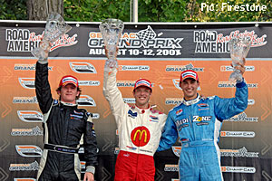 Dan Clarke on the podium at Road America with Sebastien Bourdais and Graham Rahal