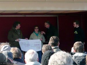 Yvonne Bennett of the Donington Park Racing Association Club presents a cheque to Kevin Wheatcroft, while event organiser Lee Coombs watches