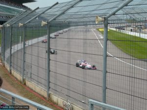 The Formula Renault UK field enters turn one at Rockingham